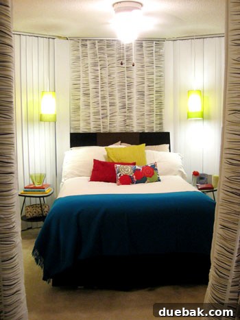 Close-up after photo of the bedroom, highlighting details like the pendant lights, custom headboard, and decorative pillows.