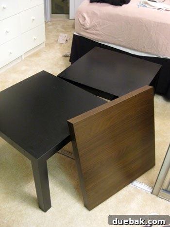 Close-up of the partially assembled DIY headboard using Ikea Lack tables, showing the different wood tones.