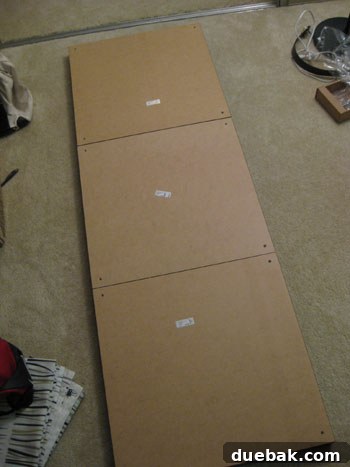 DIY headboard assembly step 1: Ikea Lack table tops arranged upside down.
