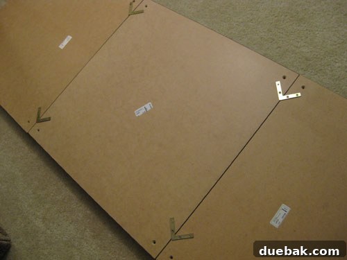 DIY headboard assembly step 2: Connecting Lack table tops with metal brackets.