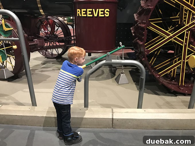A collection of vintage tractors and agricultural equipment on display at the museum.