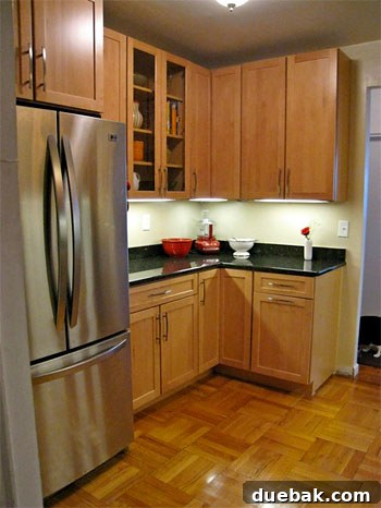 After photo 1: Renovated NYC kitchen featuring sleek stainless steel appliances and new cabinetry