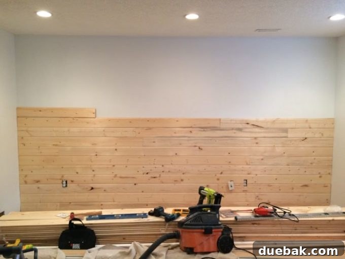 Installing shiplap planks on the wall