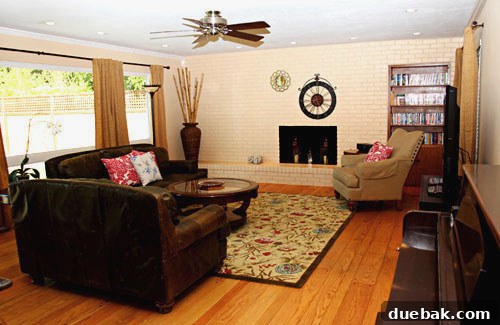 Amy's transformed living room after the mood board makeover, featuring a painted fireplace and warm tones