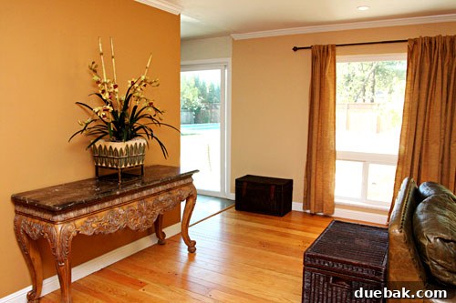 Detailed view of Amy's updated living room fireplace and accent wall in warm caramel tones