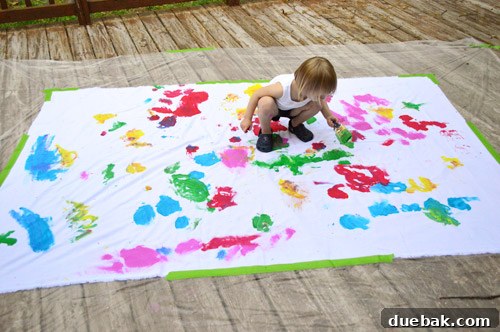 Clara intensely focused on painting her custom birthday fabric