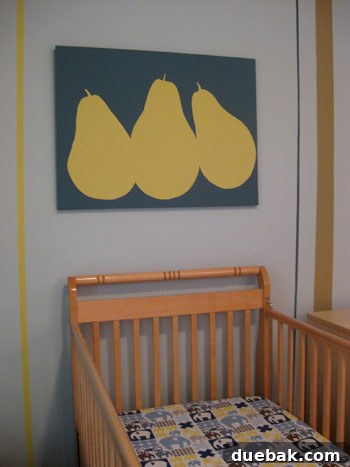 The pear painted canvas artwork prominently hung on the nursery wall, adding a touch of personalized charm.