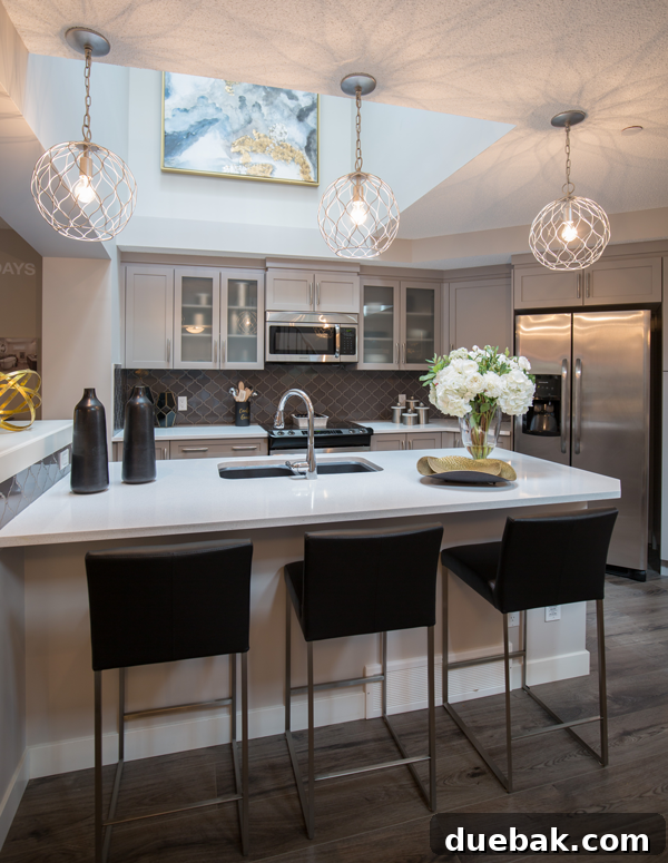 Kitchen view showing light grey cabinets and dark tile flooring