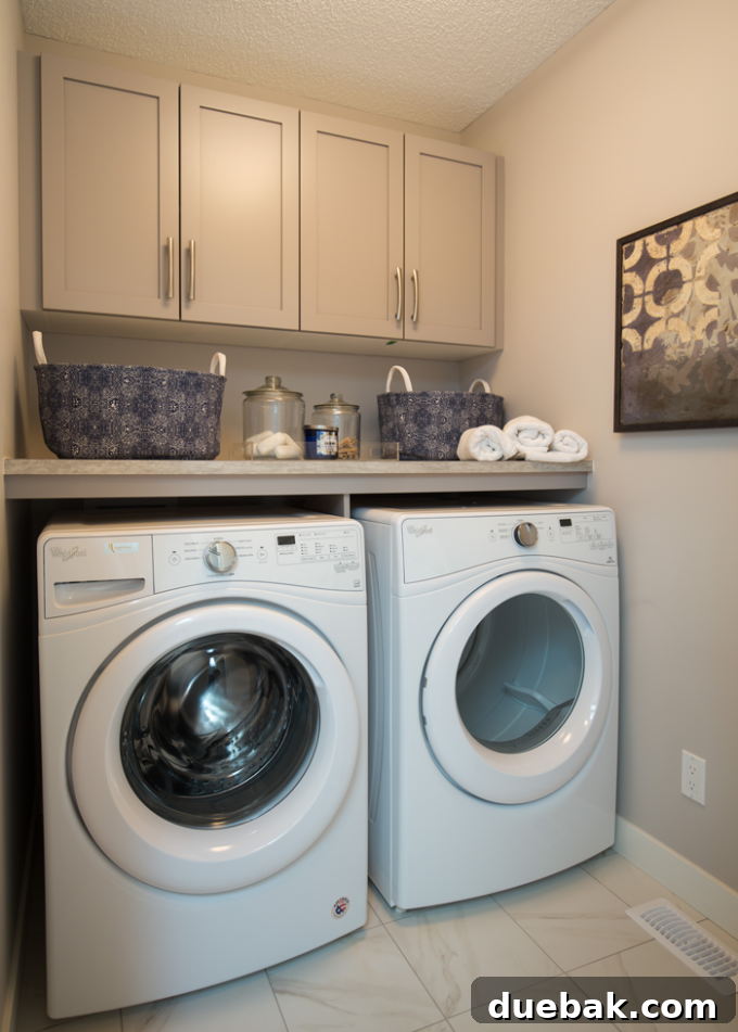 Dedicated laundry room with appliances and storage
