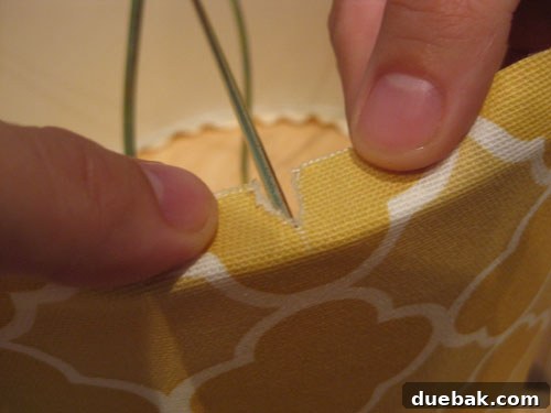 DIY Fabric Lamp Shade Makeover 13 Close-up of the lampshade's internal metal rods with fabric neatly snipped and glued around them.