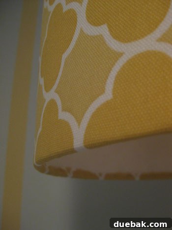 DIY Fabric Lamp Shade Makeover 15 Close-up detail shot of the yellow patterned fabric on the custom lampshade.