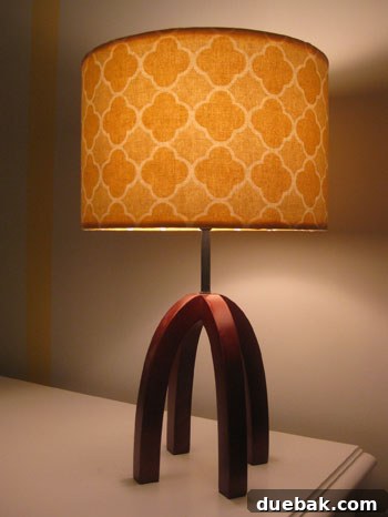DIY Fabric Lamp Shade Makeover 16 The completed table lamp in the nursery, fully illuminated and glowing.