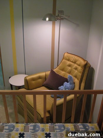 DIY Fabric Lamp Shade Makeover 4 Close-up of the swing arm lamp over the nursing chair, highlighting its design.