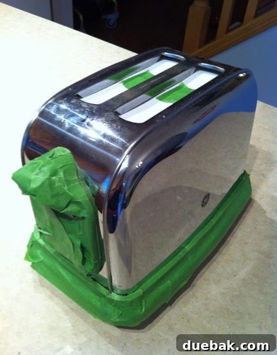 Close-up of a freshly painted yellow toaster, highlighting the smooth finish achieved with engine enamel spray paint.