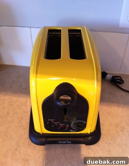 Stylish kitchen countertop featuring a newly painted yellow toaster, standing out as a bright focal point.