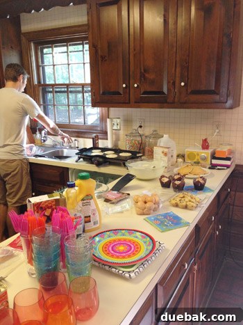 Breakfast spread with pancakes, scrambled eggs, and party plates