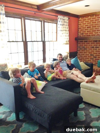 Six young children playing together in a living room, looking calm