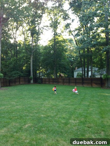 Clara playing in a backyard with a new friend at a neighbor's barbecue
