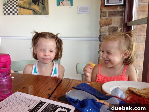 Children enjoying outdoor play and eating lemons on the deck