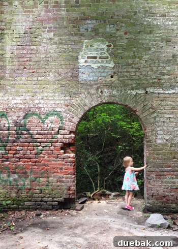 Toddler Clara exploring rocks on Belle Isle, Richmond, enjoying nature during a family walk.