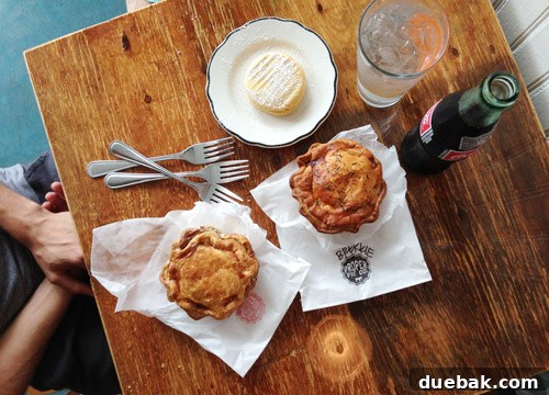 Delicious savory pies from Proper Pie Co, Richmond, arranged on a table with drinks, perfect for an anniversary lunch.