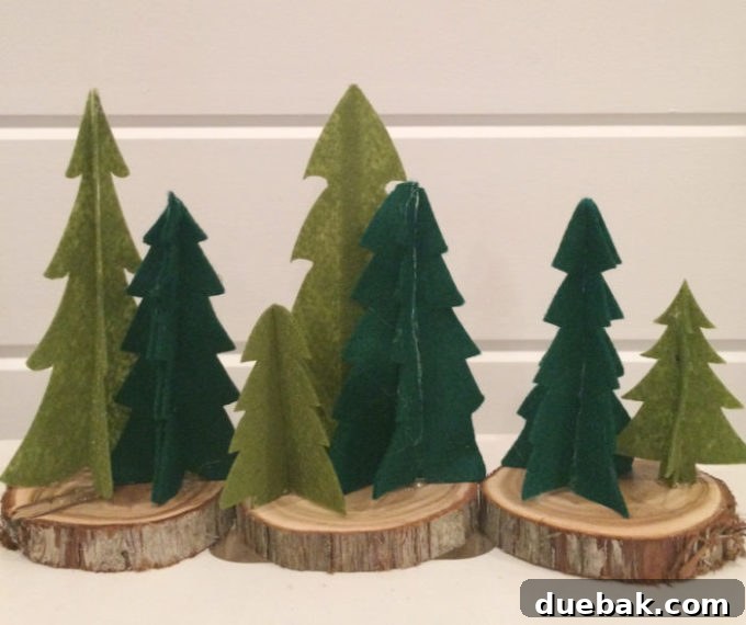 Mini felt Christmas trees under a glass cloche
