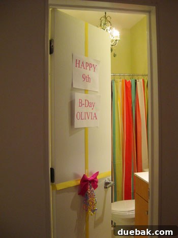 The bathroom door wrapped like a birthday present for Olivia's special reveal