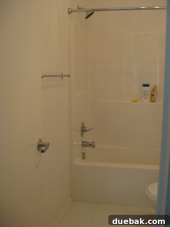 Olivia's attached bathroom before the makeover, looking plain and dated