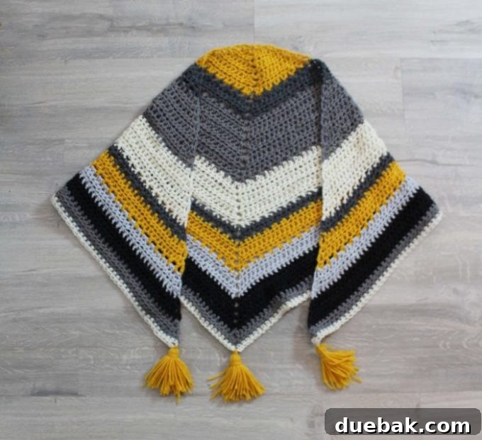 Statement Crochet Pointed Shawl 2 Beautiful oversized crochet triangle scarf draped over a person, perfect for autumn