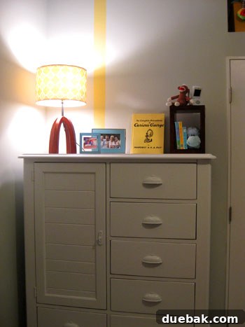 Full view of the nursery showing the crib, armoire, and mirrors