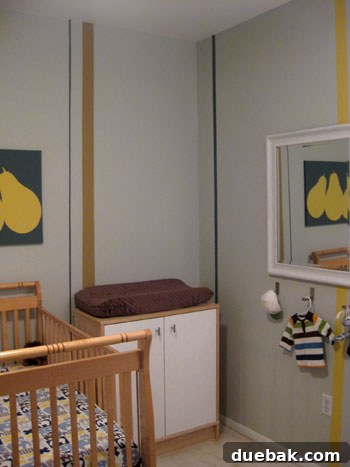 Nursery changing table with closed doors and silver knobs