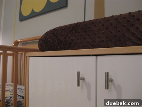Close-up of changing table with changing pad and storage
