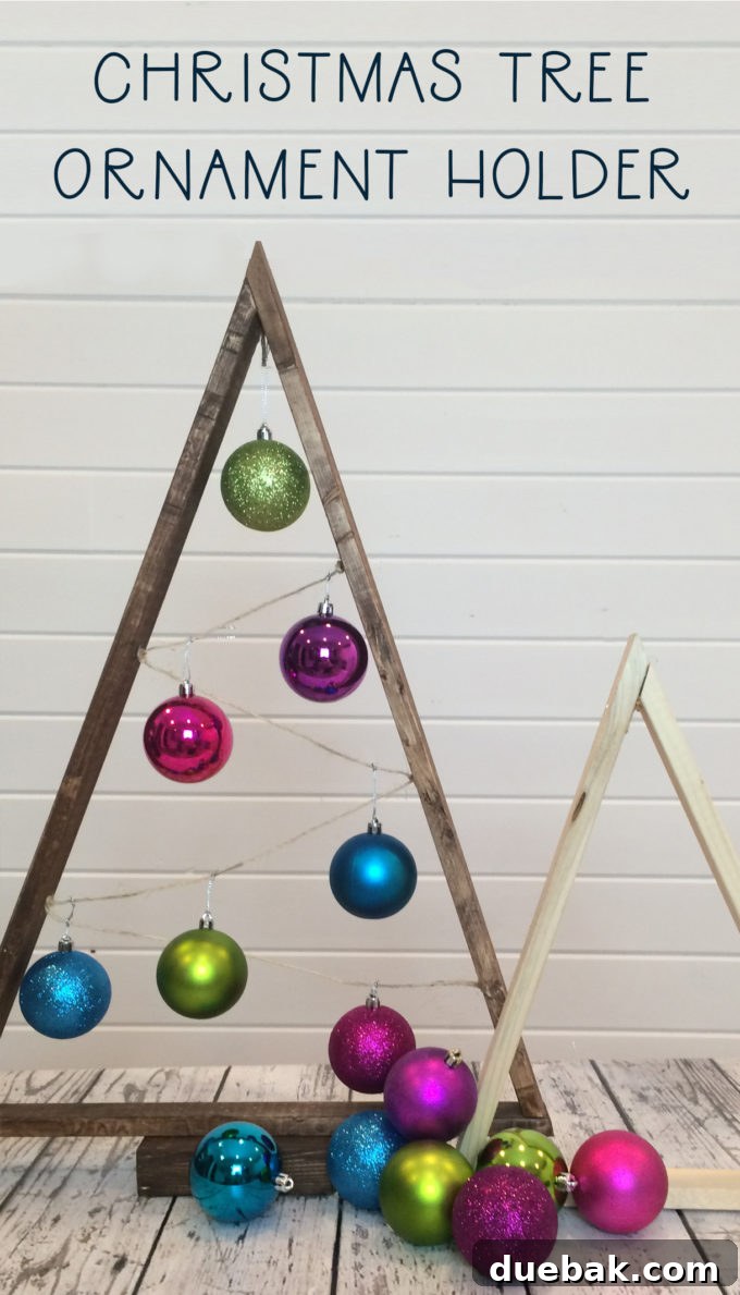 Canadian Christmas Ornament Tree Craft Hop 3 Detailed shot of a DIY Wooden Christmas Ornament Tree with grey stain, showcasing various hanging ornaments and rustic appeal.
