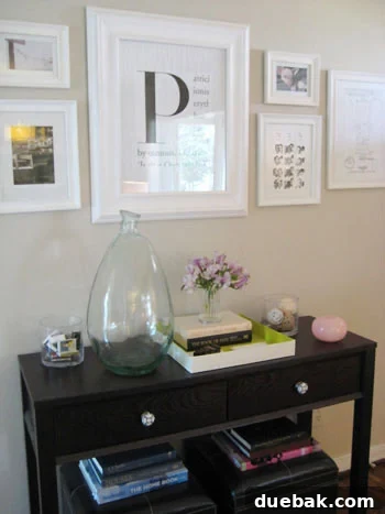 Modern console table decor with a black and white framed initial 'P' print