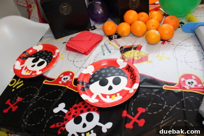 Pirate party decor with themed serving dishes and gold coins