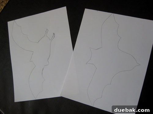 Sketches of bat shapes on white paper