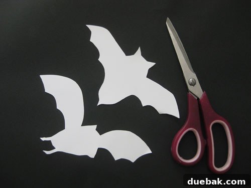 White paper stencils of bat shapes
