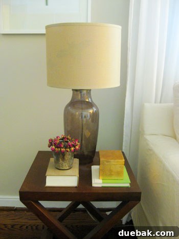 Lamp off, bat silhouette invisible within the linen shade