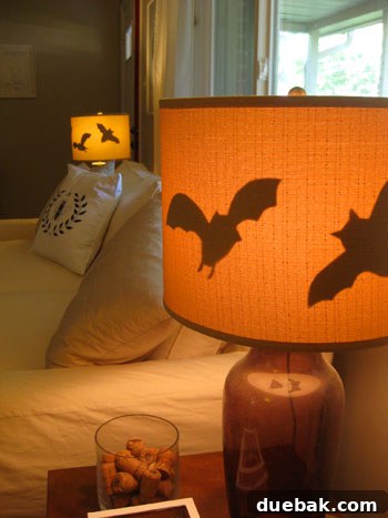 Lamp on, revealing glowing bat silhouettes