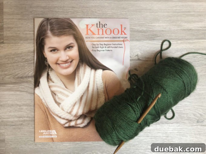 Close-up of a Knook hook with a cord threaded through it, showing initial stitches.