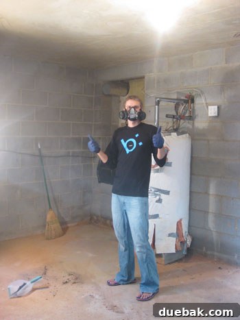Person wearing a gas mask during basement waterproofing