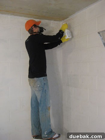 Man wearing socks with flip-flops to protect from paint splatter in basement