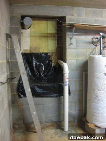 Basement wall showing a strange trap-door to a crawl space