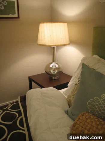 Guest bedroom with an oversized glass gourd lamp