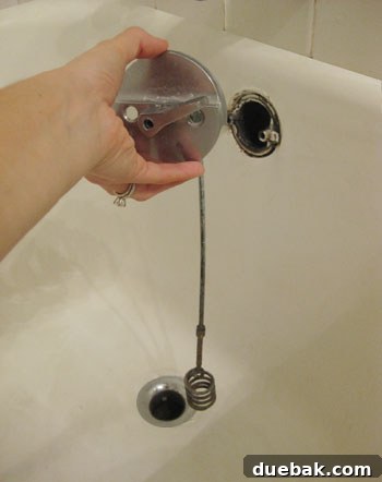 removing overflow cover in clogged bathroom drain