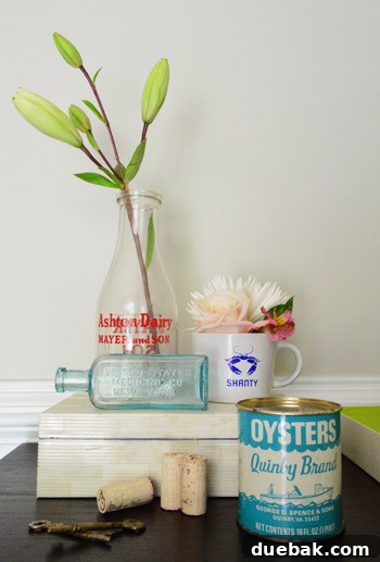 Collection of vintage souvenirs from Virginia's Eastern Shore, including bottles, oyster can, and keys