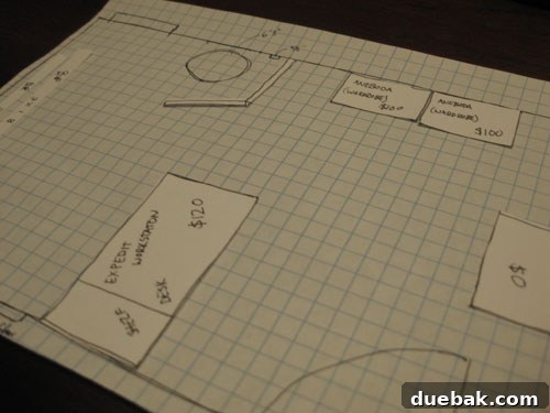 Hands demonstrating graph paper planning with furniture cutouts