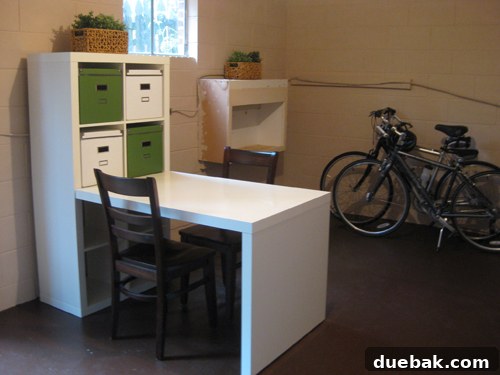 Another perspective of the basement showing the existing built-in cabinet and surrounding organized space with new Ikea furniture.