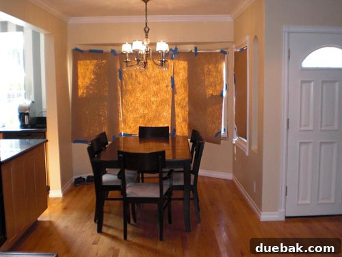 A Capiz Chandelier Elevates This Kitchen Nook Makeover 2 Before photo of a living room with mismatched furniture and a neutral palette, lacking distinct style.