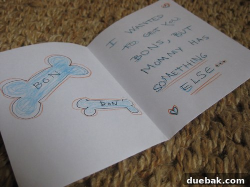 Inside of Burger's card to John, revealing the message 'I wanted to get you bons but mommy has something else...', a humorous lead-in to pregnancy news.